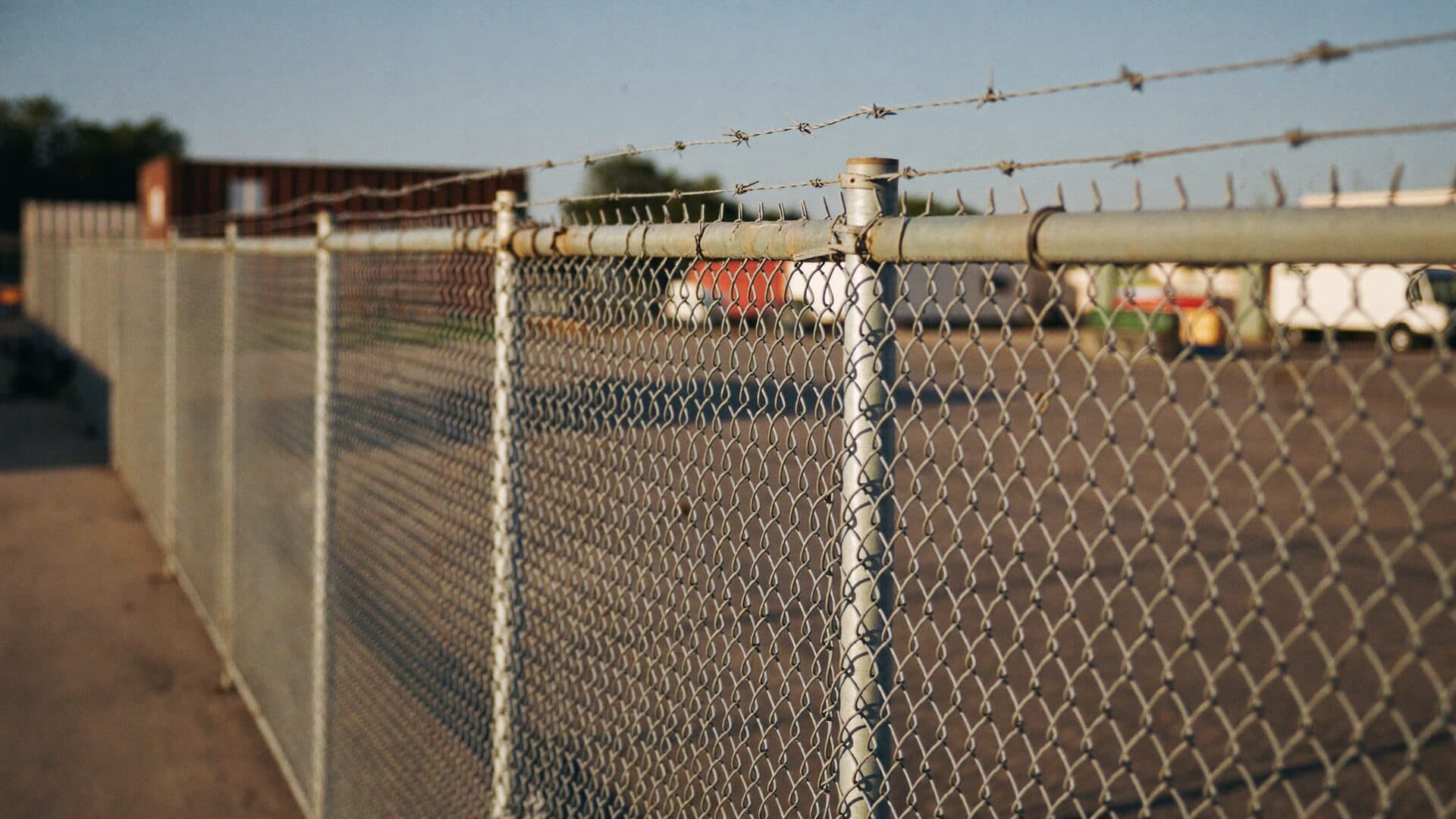 Black vinyl chain link perimeter fence installed at a rural Northeast Florida property